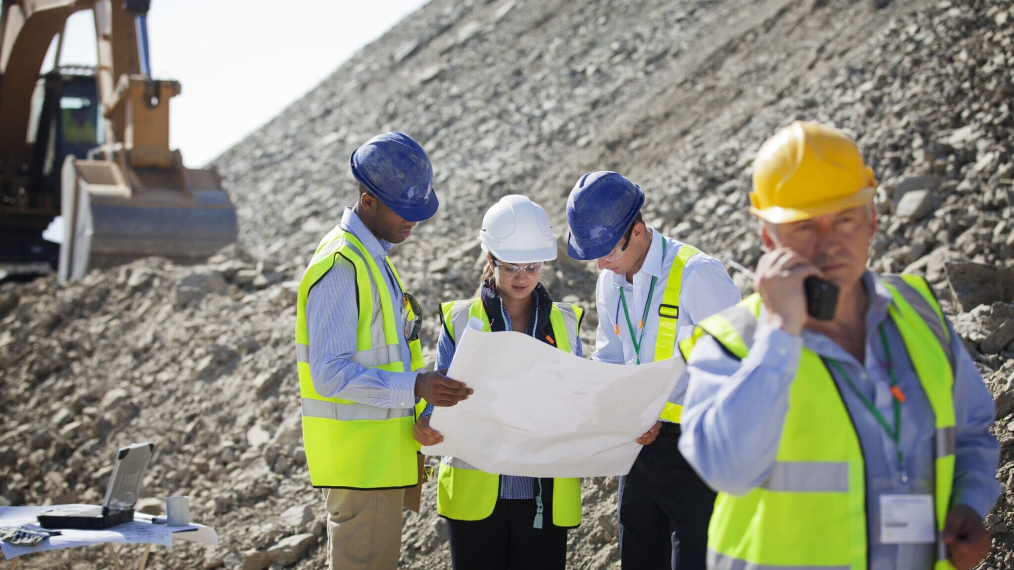 Businesspeople talking in quarry