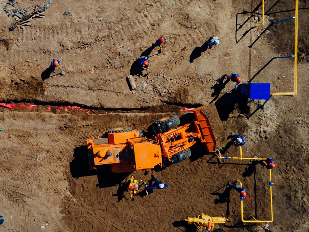 Aerial view excavator and construction workers working