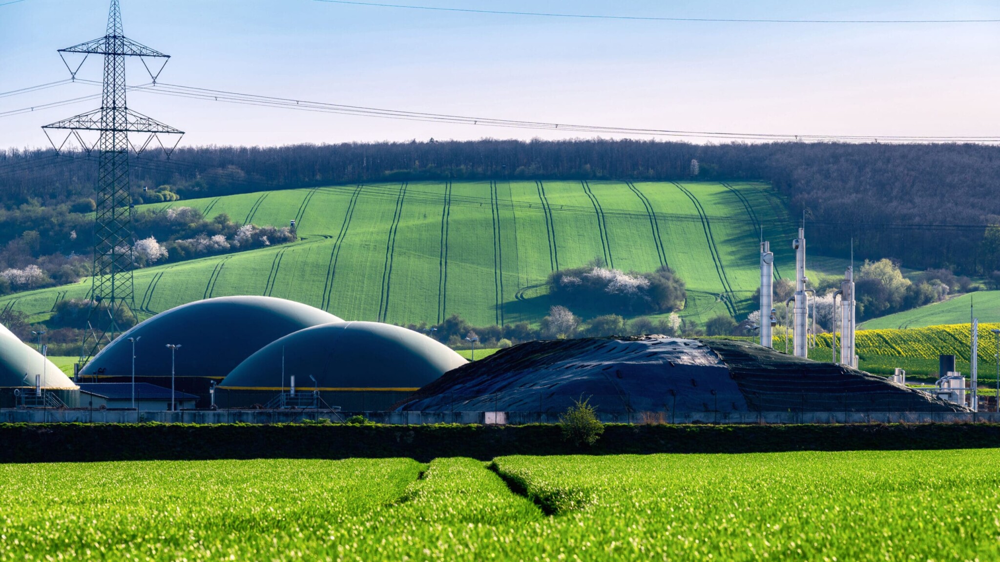 View over a field to a biogas plant