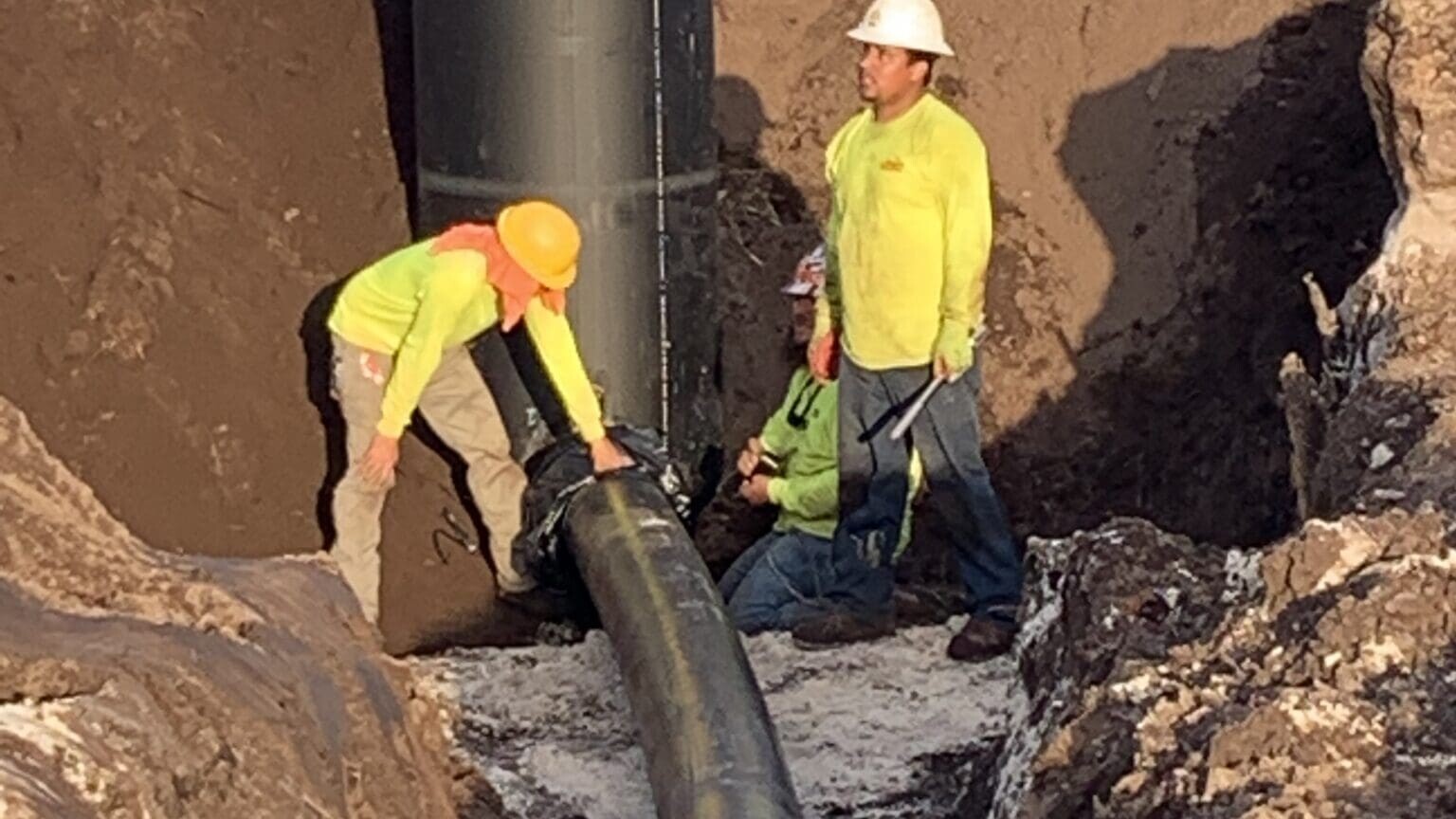 Men working on pipe installation